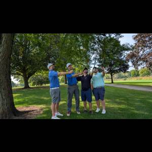 Golfers with clubs in the air