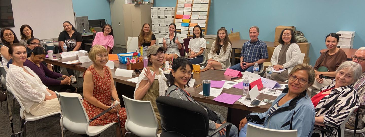 diverse group of POC participants in adult education program around a conference table