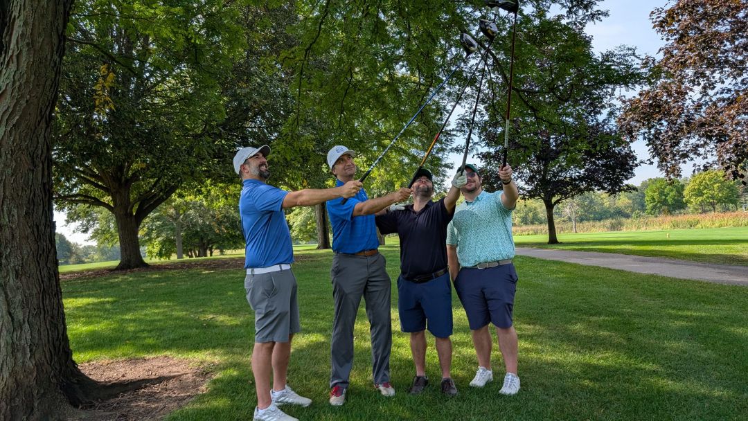 Golfers with clubs in the air